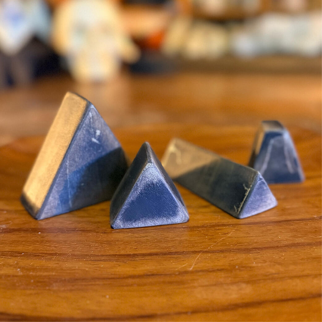 Bone bells - Each its own shape Row of standing bone bells in varied shapes and finishes, sealed wooden rattle totems, WMFrewolfe