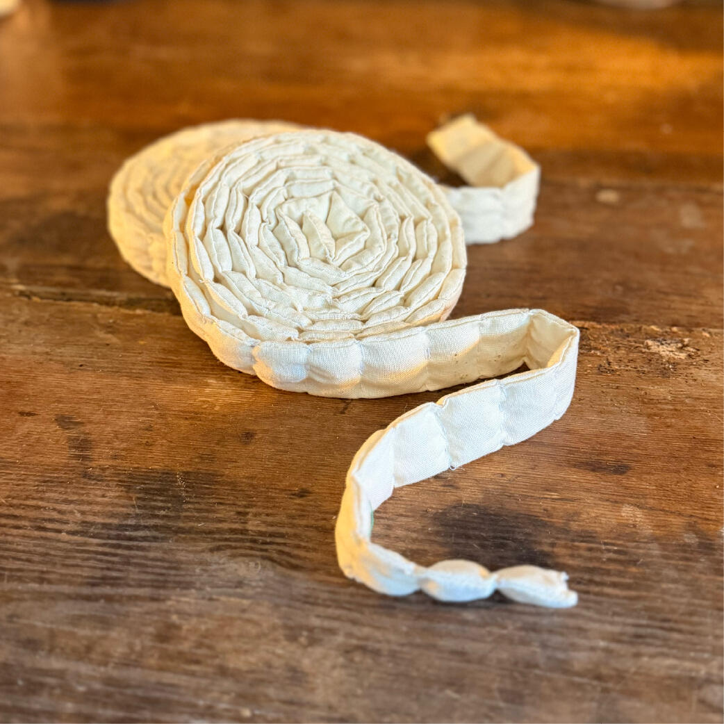Saltcord - Coiled to keep Handmade segmented salt-filled cloth cord coiled with its tail unspooled, reusable salt ward, two shown, Saltcord by WMFrewolfe